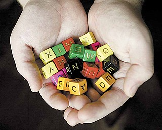 Travis displays dice from a LinguiSHTIK game. LinguiSHTIK is one of six academic games provided at the Academic Games Leagues of America tournament.