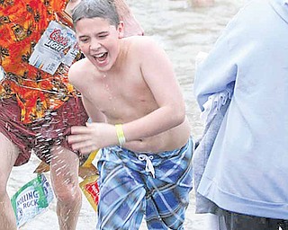 Dustin Murray, 12, of West Middlesex, Pa., runs out of the Shenango River. Saturday was the first time he participated in the Polar Bear Jump.