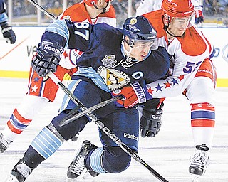 Pittsburgh Penguins' Sidney Crosby (87) is held by Washington Capitals' Mike Green in the first period of the NHL Winter Classic outdoor hockey game in Pittsburgh, Saturday, Jan. 1, 2011.