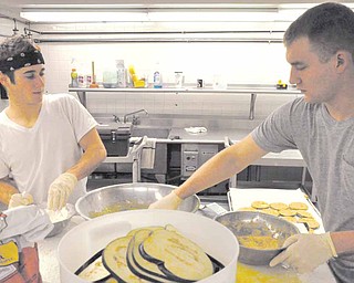 Members of Ohio Valley Teen Challenge work in the kitchen of the rehabilitation center in Youngstown. Thanks to an outpouring of donations, the program's kitchen and catering service has been expanded.