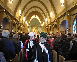 Knights of Columbus exit the church during the final service. Parish members said they felt as if they had lost a member of the family when the church announced it would close.
