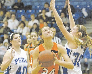 Howland's #24 Taylor Williams shoots through Poland's Allison Berend, left, and Maura Bobby during first-half action at Poland Monday.