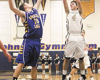 Gerrod Hrusovsky (4) shoots for two as Erik Baker (10) tries for the block during their game Tuesday night in Lowellville.