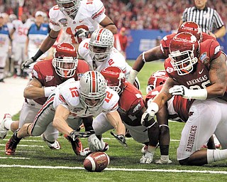 Ohio State wide receiver Dane Sanzenbacher (12) dives on a fumble in the end zone for a touchdown against Arkansas during the Sugar Bowl NCAA college football game at the Louisiana Superdome in New Orleans, Tuesday, Jan. 4, 2011. (AP Photo/Patrick Semansky)