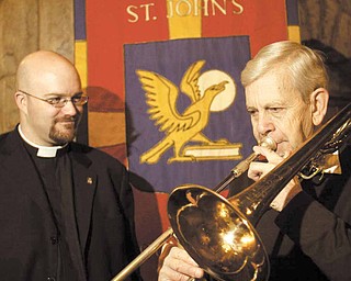 James Hummer plays the trombone for the Rev. Dr. Bradley Pace, rector of St. John’s Episcopal Church in Youngstown. In the brass ensemble, Hummer has participated in all 50 years of the Boar’s Head and Yule Log Festival. The Rev. Dr. Pace, who became rector at St. John’s last summer, will be a first-time pageant participant at the Sunday event.