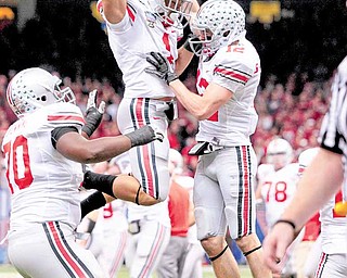 Ohio State wide receiver Dane Sanzenbacher (12) celebrates his touchdown with running back Dan Herron (1) in the second quarter of the Sugar Bowl NCAA college football game against Arkansas at the Louisiana Superdome in New Orleans, Tuesday, Jan. 4, 2011.