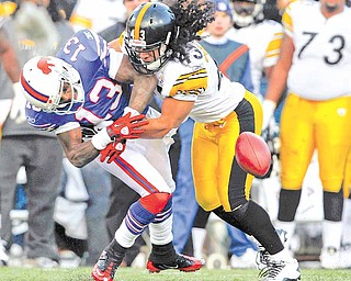 In this Nov. 28, 2010, file photo, Pittsburgh Steelers' defender Troy Polamalu (43) breaks up a pass intended for Buffalo Bills' wide receiver Steve Johnson (13) during the second half of an NFL football game in Orchard Park, N.Y. The Steelers were reminded again what they were missing when Polamalu was injured for most of the season. Against Buffalo, his instinctive play preserved their chances of winning their division.