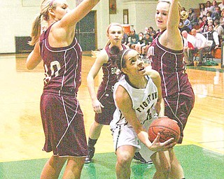 Villida Whitehead (14) drives to the hoop as Kayleigh Lipke (40), Jenna Kuczek (33) and Brooke Meenachan (21) play defense during their game Wednesday night in Youngstown.