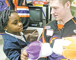 Unique Moore is shown here in this January 2011 photo with Youngstown Phantoms hockey player Adam Berkle. The 5-year-old died Monday in Akron Children’s Hospital, Akron, where she was taken after being pulled Sunday afternoon from Willow Lake Park campground swimming pool in Champion Township in Trumbull County.