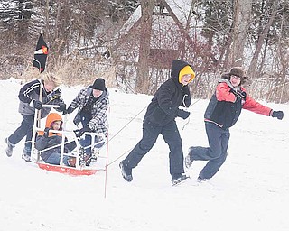 Boy Scouts from Troop 46 in Boardman head for the finish line in sled races. Saturday’s derby featured competition in outdoor activities testing Boy Scouts’ skills.