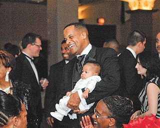 Mayor Jay Williams and his son Ethan meet and greet attendees of the Mayor's Community Celebration at Stambaugh Auditorium.