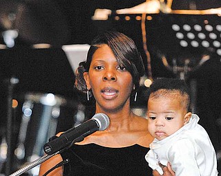 Sonja Williams, wife of Mayor Jay Williams, and their son Ethan welcome the attendees of the Mayor's community Celebration at Stambaugh Auditorium on Saturday.