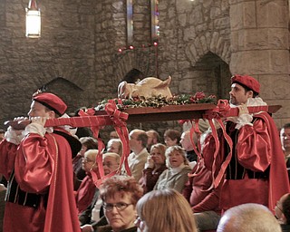 The boar’s head, symbolizing the triumph of Christ over evil, is carried into St. John’s Episcopal Church, 323 Wick Ave., Sunday to mark the 50th anniversary of the Youngstown church’s Boar’s Head and Yule Log Festival, which is held annually on the second Sunday in January.
