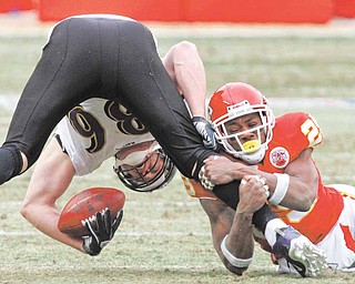 Kansas City Chiefs safety Eric Berry tackles Baltimore Ravens tight end Todd Heap during the first quarter of an NFL AFC wild card football playoff game Sunday, Jan. 9, 2011, in Kansas City, Mo.