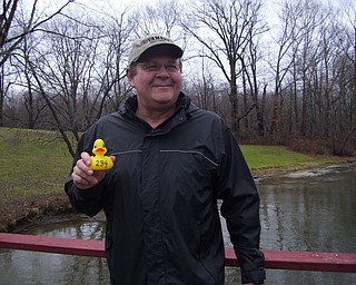 Bud Sworak proudly displays his duck, No. 234, the 2011 Champion, which nosed out other competitors by a bill for the title.