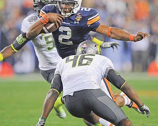 Auburn's Cam Newtown runs with the ball as Oregon's Michael Clay (46) moves in during the second half of the BCS National Championship NCAA college football game Monday, Jan. 10, 2011, in Glendale, Ariz.