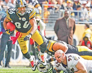 Pittsburgh Steelers receiver Hines Ward (86) makes a second quarter catch during an NFL football game against the Baltimore Ravens in Pittsburgh, Sunday, Oct. 3, 2010. At right is Ravens Jarret Johnson (95)