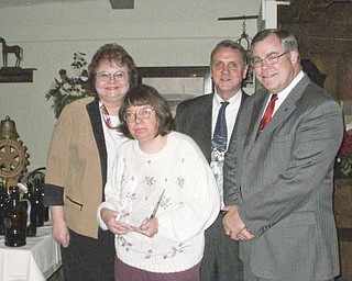 Sharing one of the special moments during an annual Mercer Rotary Club holiday party were, from left, Grace Anna Boggs, club vice president; Gail Habbyshaw, who was the recipient of the Dr. Bernard Hoyt Community Service Award; Walt Johnson, secretary; and Tom Jones, past president.