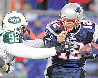 New York Jets defensive end Shaun Ellis (92) sacks New England Patriots quarterback Tom Brady (12) during the first half of an NFL divisional playoff football game in Foxborough, Mass., Sunday, Jan. 16, 2011.