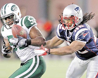 New York Jets linebacker David Harris (52) makes an interception in front of New England Patriots running back BenJarvus Green-Ellis (42) on a pass thrown by Tom Brady during the first half of an NFL divisional playoff football game in Foxborough, Mass., Sunday, Jan. 16, 2011.