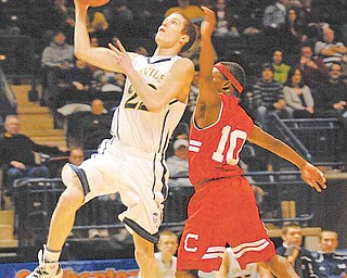 McDonald Blue Devil Patrick Kunkel goes for a lay up while being defended by Columbiana Clipper Mardell Halas.