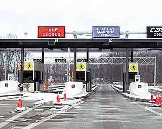 Problems at this automated toll booth at the Ohio Turnpike exit near the General Motors complex in Lordstown have some employees taking a different route to and from work at the plant. The lane at which a toll collector had been stationed was closed.