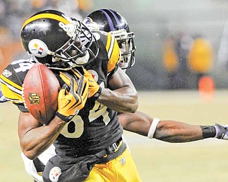 In this Jan. 15, 2011, file photo, Pittsburgh Steelers wide receiver Antonio Brown (84) beats Baltimore Ravens cornerback Lardarius Webb on a long pass during the second half of an NFL divisional playoff football game in Pittsburgh. The play set up Rashard Mendenhall's touchdown to give the Steelers the 31-24 win. Three catches and 75 yards later, the Central Florida product is drawing national attention.