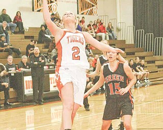 Howland's Olivia Nicholas (2) drives to the hoop Wednesday night in Howland, as Green's Lydia Covle (15) looks on.