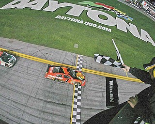 In this Feb. 14, 2010, file photo, Jamie McMurray (1) followed by Dale Earnhardt Jr. (88) crosses the finish line to win the the NASCAR Daytona 500 auto race at Daytona International Speedway in Daytona Beach, Fla. McMurray won at NASCAR's three most prominent tracks last season, including the Daytona 500. He didn't make the Chase for the Sprint Cup championship. That wouldn't be the case under a proposed format, a hot-button issues as drivers prepare for next month's Super Bowl of stock car racing.