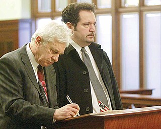 David J. Venerose Jr., 40, of Sheridan Road, right, appears for arraignment on felony charges of passing bad checks and perjury. With him is his lawyer, J. Gerald Ingram. They appeared Wednesday before Magistrate Dominic DeLaurentis of Mahoning County Common Pleas Court.