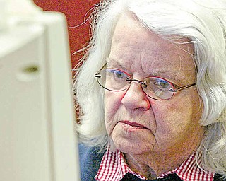 Penny Gunter concentrates in a computer class at Hubbard Public Library. The Hubbard resident is taking the free instruction so she can use e-mail to communicate with a sister in Denver and access the library’s card catalog from her home.