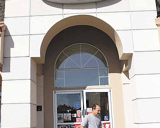A customer leaves a A&W restaurant in Millbrae, Calif., Tuesday, Jan. 18, 2011. Yum Brands Inc. is putting its Long John Silver's and A&W restaurant chains up for sale so it can focus on its growing international business.