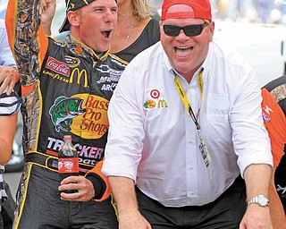 This July 25, 2010 file photo shows Jamie McMurray, left, and car owner Chip Ganassi celebrating on the start-finish line after McMurray won the NASCAR Brickyard 400 auto race at Indianapolis Motor Speedway in Indianapolis. Ganassi never listened when anyone counted his race teams out. That persistence helped the car owner collect major hardware in every major American series. That's not enough for Ganassi, who continues to prove his worth in NASCAR. 