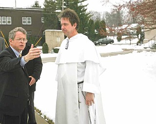 Ohio Attorney General Mike DeWine, left, met with the Rev. Greg Maturi at St. Dominic Church, 77 E. Lucius Ave., to discuss the crime problem in Youngstown. The attorney general was here Tuesday and said the process of reducing the city’s crime rate was ongoing.
