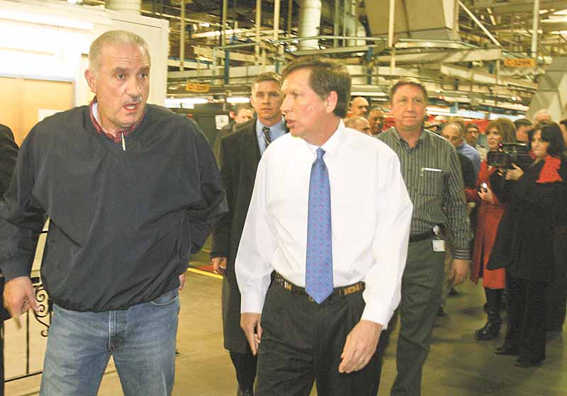 Finishing a brief tour of the Lordstown General Motors assembly plant, Gov. John Kasich, right, talks with Jim Graham, president of the United Auto Workers Local 1112. Kasich chose the auto facility as the location for his first official visit in Northeast Ohio as governor.