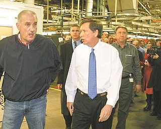 Finishing a brief tour of the Lordstown General Motors assembly plant, Gov. John Kasich, right, talks with Jim Graham, president of the United Auto Workers Local 1112. Kasich chose the auto facility as the location for his first official visit in Northeast Ohio as governor.