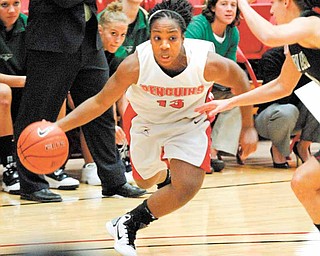 Closely guarded by Green Bay's Celeste Hoewisch, YSU's Macey Nortey drives to the basket. .