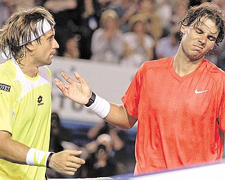 Spain's Rafael Nadal, right, reacts as he talks with compatriot David Ferrer at the net after his quarterfinal loss to Ferrer at the Australian Open tennis championships in Melbourne, Australia, Wednesday, Jan. 26, 2011. 