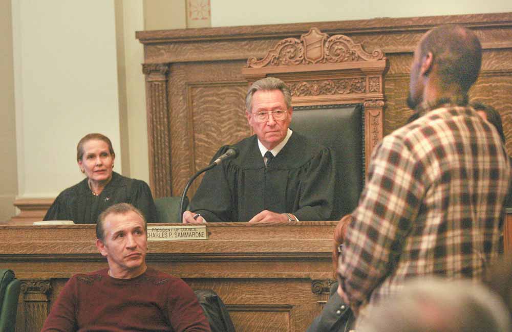 Youngstown Municipal Judge Robert P. Milich presides over the first session of the Youngstown Veterans Treatment Court on Wednesday in city council chambers. At right is Todd Stratton, a veteran who applied to participate in the Treatment Court’s program, which if completed, can keep him from going to jail. Looking on is Ohio Supreme Court Justice Evelyn Stratton and former professional boxer Ray “Boom Boom” Mancini, who is interested in veterans issues.