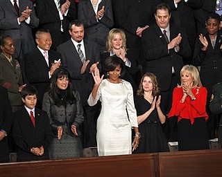 First lady Michelle Obama waves on Capitol Hill in Washington, Tuesday, Jan. 25, 2011, prior to the start of President Barack Obama's State of the Union address.  (AP Photo/Evan Vucci)