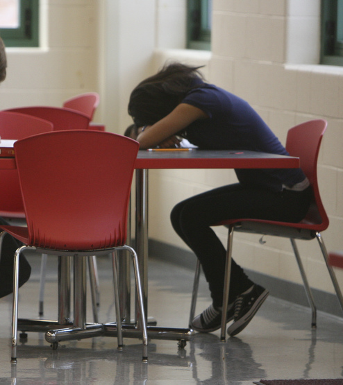 A student rests on a table at Youngstown's Chaney High School.