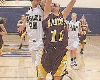 (10) Mckenzie Pfeifer of South Range glides to the hoop as (20) Crystal Richards goes for the block Thursday night.