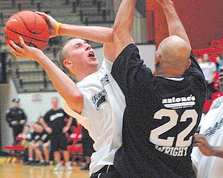 YSU Student Chad Gifford goes up against former Cleveland Browns player Felix Wright during the Game of Hope Saturday Evening at the Beeghly Center.