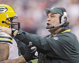 Green Bay Packers' Johnny Jolly, left, talks with defensive line coach Mike Trgovac in the second quarter of an NFL football game against the Arizona Cardinals Sunday, Jan. 3, 2010, in Glendale, Ariz.  The Packers defeated the Cardinals 33-7. 