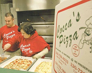 William D. Lewis|The Vindicator  SteveCocca and his mother Tina Cocca whose family owns Cocca's Pizza at work in thier New Middletown pizzaria.