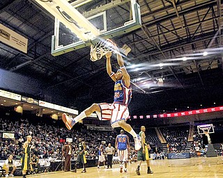 Harlem Globetrotter Hacksaw Hall wows the audience at the Covelli Center with multiple high flying dunks Saturday afternoon.