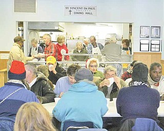 Volunteers serve lunch for needy people at St. Vincent DePaul Society Dining Hall in Youngstown. In 2010, the facility served 91,000 meals