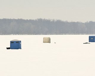 ROBERT K. YOSAY | THE VINDICATOR..Ice Fishing is cool - The right spot seems to attrack several fisherman  as the popular winter sport adds color to a dreary winter day... Ó--30-..