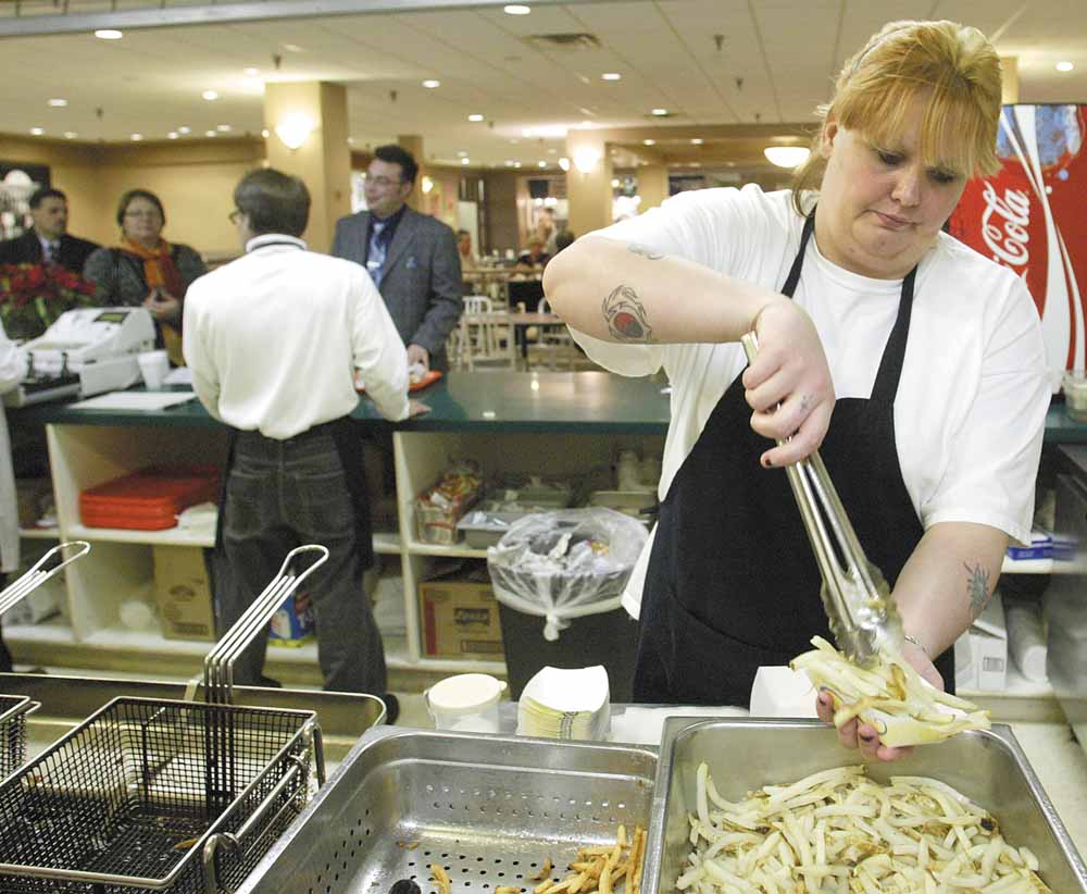 Theresa Smith, who works at the Capitol Grill in the 20 Federal Place food court, prepares french fries during the afternoon lunch crowd at the downtown Youngstown office building.