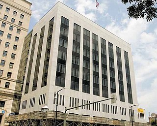 It will be another five to six months before scaffolding around the PNC Bank Building in downtown Youngstown is removed. The owners of the building want to install 54 metal strips to the building to stabilize granite panels on its exterior.